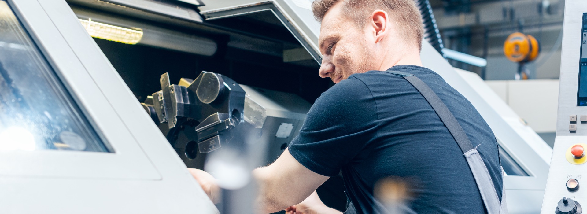 Experienced worker changing tool setup of lathe machine